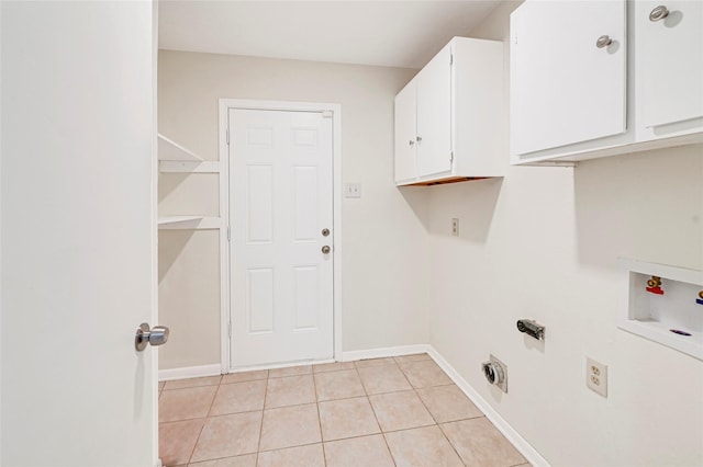 9306 Claridge Dr, Houston, TX 77031 - laundry room featuring cabinet space, hookup for a washing machine, light tile patterned floors, and hookup for an electric dryer
