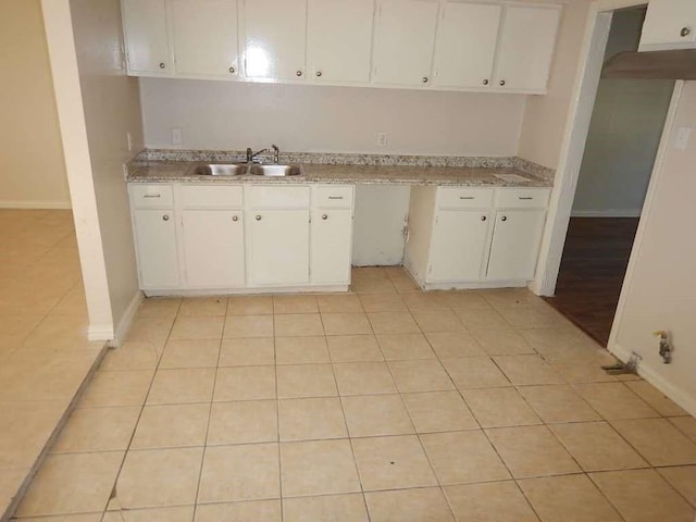 5131 Nassau Rd, Houston, TX 77021 - kitchen with white cabinets, light countertops, and light tile patterned flooring