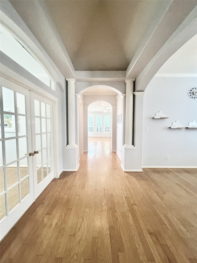 1150 Sienna Hill Dr, Houston, TX 77077 - hallway featuring ornate columns, arched walkways, light wood-type flooring, french doors, and crown molding