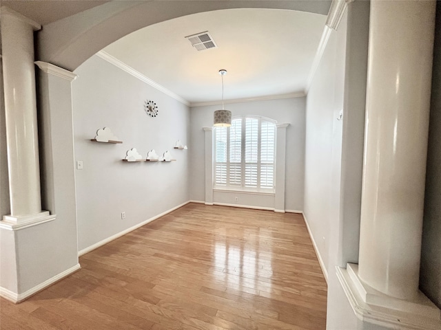 1150 Sienna Hill Dr, Houston, TX 77077 - unfurnished dining area with arched walkways, crown molding, light wood-type flooring, and ornate columns