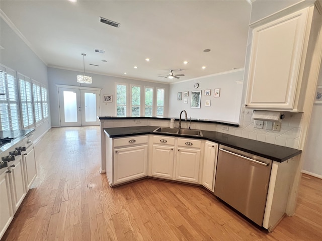 1150 Sienna Hill Dr, Houston, TX 77077 - kitchen featuring dishwasher, crown molding, a peninsula, dark countertops, and light wood-style floors