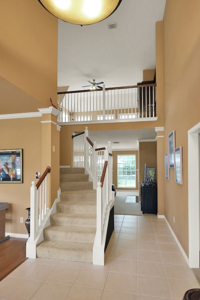 603 Forest Bend Ln, Friendswood, TX 77546 - stairway with a ceiling fan, a towering ceiling, tile patterned flooring, and ornamental molding