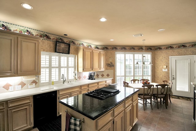 603 Forest Bend Ln, Friendswood, TX 77546 - kitchen featuring black appliances, wallpapered walls, healthy amount of natural light, backsplash, and a center island