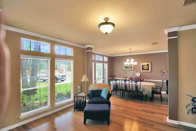 603 Forest Bend Ln, Friendswood, TX 77546 - living area featuring ornamental molding, wood finished floors, and a chandelier