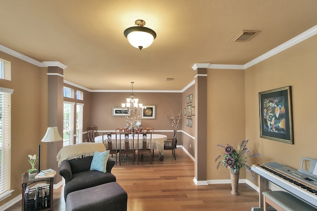 603 Forest Bend Ln, Friendswood, TX 77546 - dining space featuring wood finished floors, ornamental molding, and a chandelier