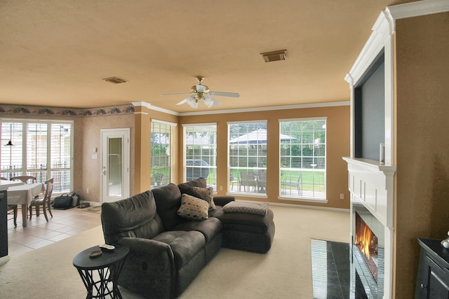 603 Forest Bend Ln, Friendswood, TX 77546 - living area featuring ceiling fan, light colored carpet, a fireplace with flush hearth, ornamental molding, and plenty of natural light