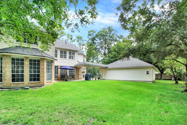 603 Forest Bend Ln, Friendswood, TX 77546 - rear view of house featuring roof with shingles, a gazebo, and brick siding