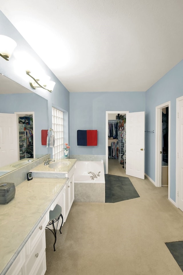603 Forest Bend Ln, Friendswood, TX 77546 - bathroom with a garden tub, vanity, and a walk in closet