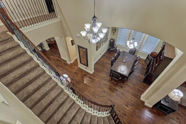 9714 Luna Springs Ln, Cypress, TX 77433 - foyer featuring a chandelier, arched walkways, wood finished floors, stairway, and a high ceiling