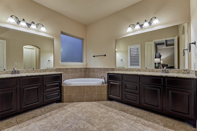 9714 Luna Springs Ln, Cypress, TX 77433 - bathroom featuring two vanities, a garden tub, and tile patterned floors