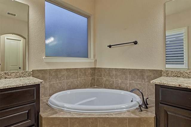 9714 Luna Springs Ln, Cypress, TX 77433 - bathroom with vanity, a bath, and a textured wall