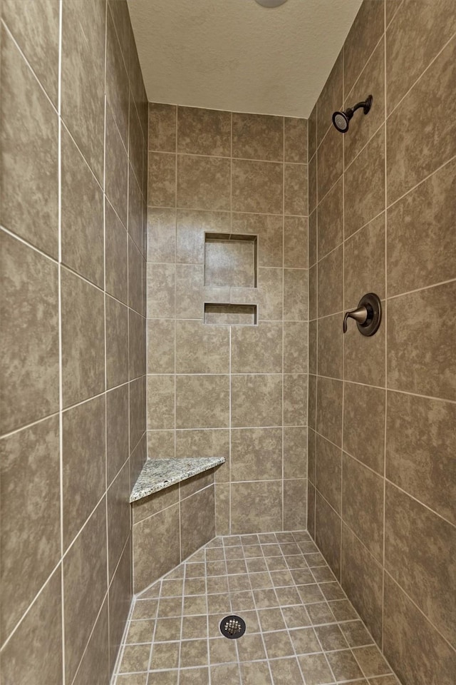 9714 Luna Springs Ln, Cypress, TX 77433 - bathroom featuring tiled shower and a textured ceiling