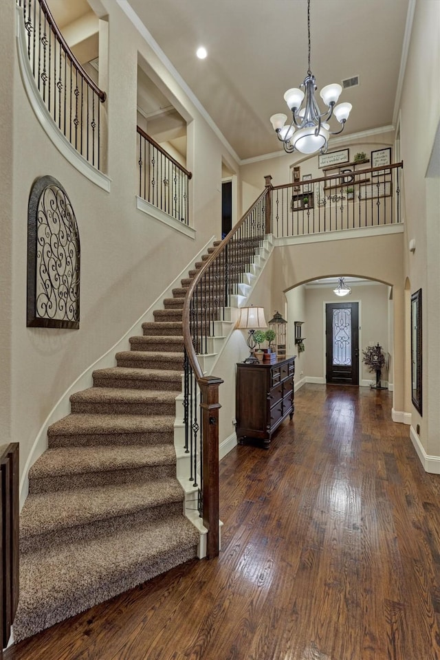 9714 Luna Springs Ln, Cypress, TX 77433 - foyer with arched walkways, stairway, wood finished floors, a chandelier, and ornamental molding