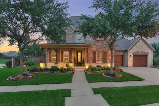 9714 Luna Springs Ln, Cypress, TX 77433 - view of front of house featuring a porch, stone siding, brick siding, and concrete driveway