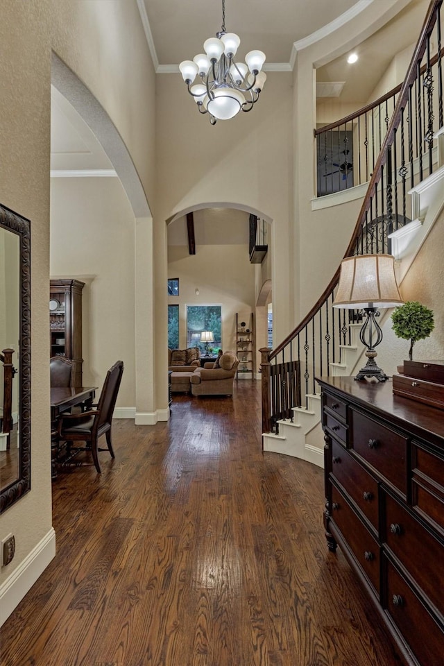 9714 Luna Springs Ln, Cypress, TX 77433 - foyer entrance with arched walkways, a chandelier, a towering ceiling, wood finished floors, and stairs