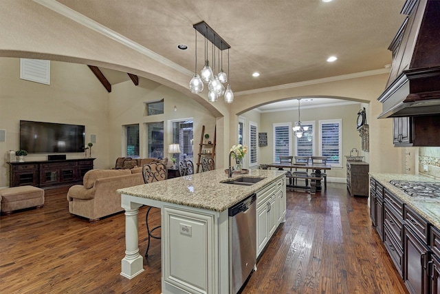 9714 Luna Springs Ln, Cypress, TX 77433 - kitchen with appliances with stainless steel finishes, arched walkways, a breakfast bar area, light stone countertops, and recessed lighting