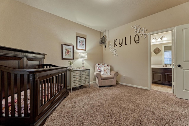 9714 Luna Springs Ln, Cypress, TX 77433 - bedroom featuring light colored carpet, a nursery area, and ensuite bathroom