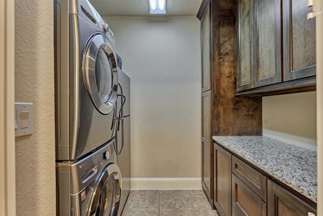 9714 Luna Springs Ln, Cypress, TX 77433 - laundry area with estacked washer and dryer, cabinet space, and a textured wall