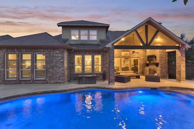9714 Luna Springs Ln, Cypress, TX 77433 - pool at dusk featuring outdoor lounge area, an outdoor pool, a patio area, and ceiling fan