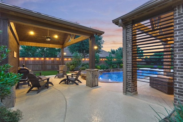 9714 Luna Springs Ln, Cypress, TX 77433 - patio terrace at dusk with a patio area, a fenced backyard, and a ceiling fan