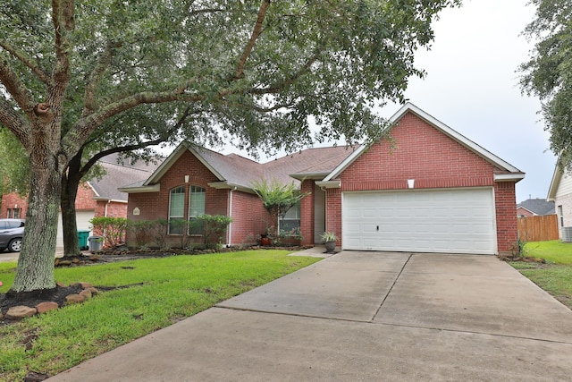 30515 Red Bluff Cir, Magnolia, TX 77355 - ranch-style home featuring brick siding, a front yard, driveway, a garage, and a shingled roof