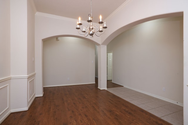 30515 Red Bluff Cir, Magnolia, TX 77355 - empty room with arched walkways, crown molding, a chandelier, and wood finished floors