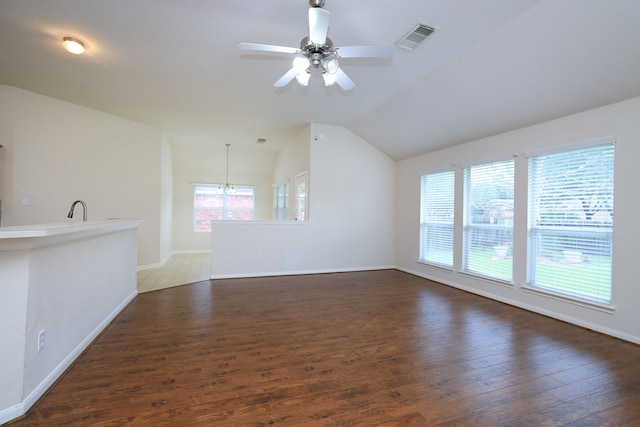 30515 Red Bluff Cir, Magnolia, TX 77355 - unfurnished living room featuring vaulted ceiling, wood finished floors, ceiling fan, and a chandelier