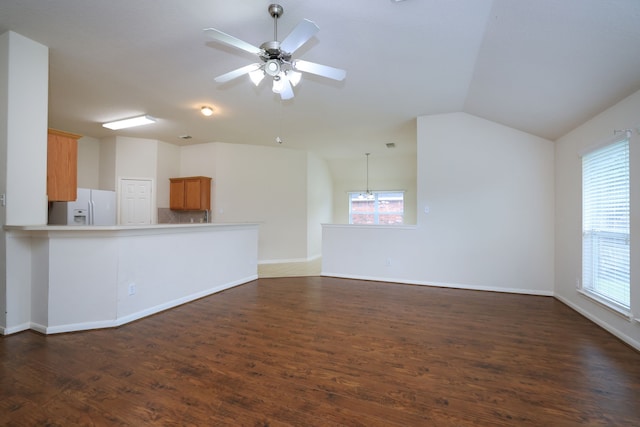 30515 Red Bluff Cir, Magnolia, TX 77355 - unfurnished living room featuring plenty of natural light, dark wood finished floors, ceiling fan, and vaulted ceiling