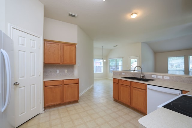30515 Red Bluff Cir, Magnolia, TX 77355 - kitchen featuring white appliances, light floors, vaulted ceiling, light countertops, and tasteful backsplash