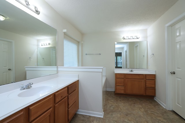 30515 Red Bluff Cir, Magnolia, TX 77355 - full bath with two vanities and a textured ceiling