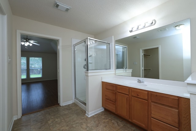 30515 Red Bluff Cir, Magnolia, TX 77355 - bathroom with vanity, a shower stall, and a textured ceiling