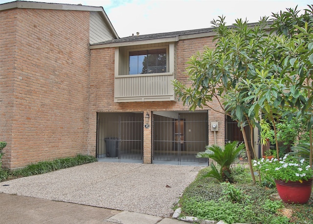 9400 Doliver Dr Unit 70, Houston, TX 77063 - view of front of property with brick siding, a gate, a garage, and driveway