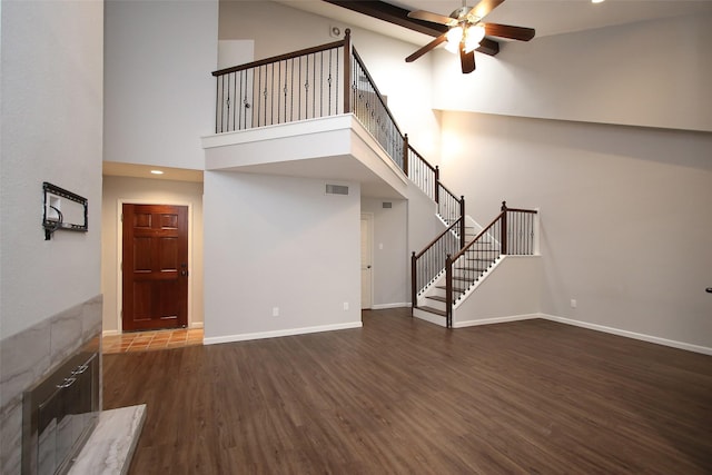 9400 Doliver Dr Unit 70, Houston, TX 77063 - unfurnished living room with a ceiling fan, high vaulted ceiling, wood finished floors, stairs, and recessed lighting