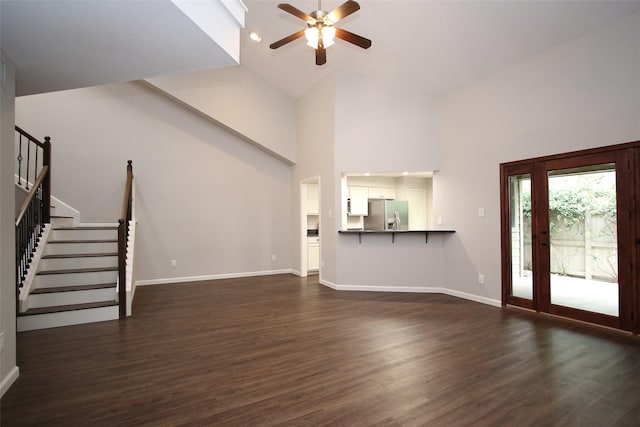 9400 Doliver Dr Unit 70, Houston, TX 77063 - unfurnished living room with ceiling fan, stairway, high vaulted ceiling, and dark wood-style floors