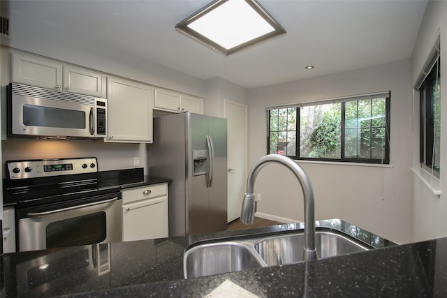 9400 Doliver Dr Unit 70, Houston, TX 77063 - kitchen with stainless steel appliances, dark stone countertops, white cabinetry, and recessed lighting