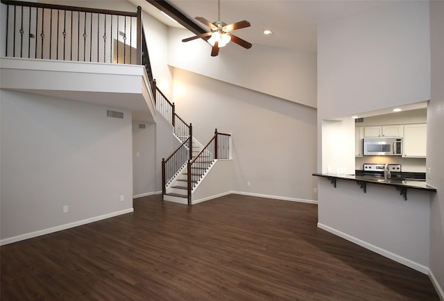 9400 Doliver Dr Unit 70, Houston, TX 77063 - unfurnished living room with high vaulted ceiling, a ceiling fan, dark wood-style floors, stairs, and recessed lighting