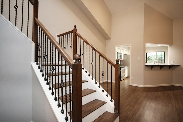 9400 Doliver Dr Unit 70, Houston, TX 77063 - stairs with wood-type flooring and a towering ceiling