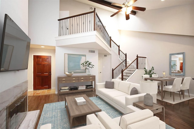 9400 Doliver Dr Unit 70, Houston, TX 77063 - living area with wood finished floors, high vaulted ceiling, ceiling fan, and stairway