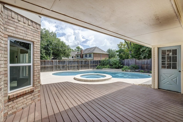 15434 Redbud Leaf Ln, Cypress, TX 77433 - view of swimming pool featuring a deck, a fenced backyard, and a pool with connected hot tub