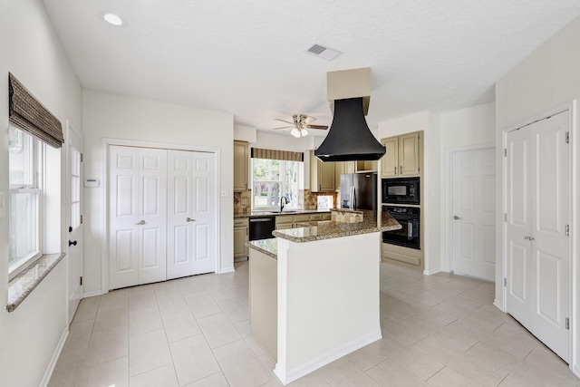 15434 Redbud Leaf Ln, Cypress, TX 77433 - kitchen with black appliances, ceiling fan, a kitchen island, tasteful backsplash, and light tile patterned floors