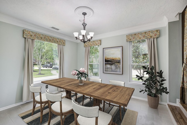15434 Redbud Leaf Ln, Cypress, TX 77433 - dining room featuring a chandelier, ornamental molding, light tile patterned floors, and a textured ceiling