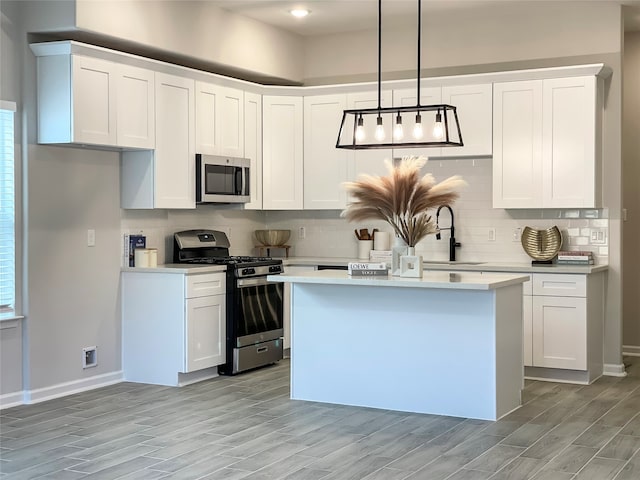 4817 Keeland St, Houston, TX 77016 - kitchen featuring appliances with stainless steel finishes, light countertops, backsplash, and light wood-style floors