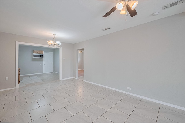 3024 Brackenridge St, Houston, TX 77026 - spare room featuring a chandelier, ceiling fan, light tile patterned floors, and a smoke detector