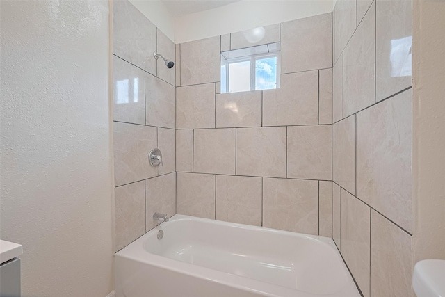 3024 Brackenridge St, Houston, TX 77026 - bathroom featuring washtub / shower combination, vanity, and a textured wall