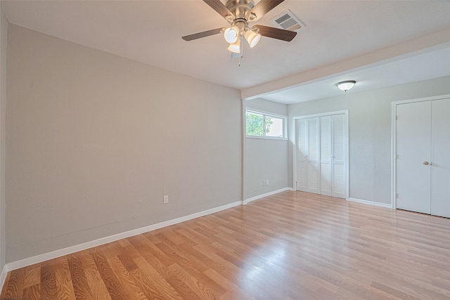3024 Brackenridge St, Houston, TX 77026 - unfurnished bedroom with light wood-style floors, two closets, and a ceiling fan