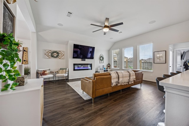 15603 Beltie Dr, Humble, TX 77346 - bedroom featuring dark wood finished floors, a glass covered fireplace, vaulted ceiling, and ceiling fan