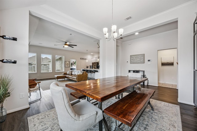 15603 Beltie Dr, Humble, TX 77346 - dining room featuring dark wood-type flooring, ornamental molding, ceiling fan, and a chandelier