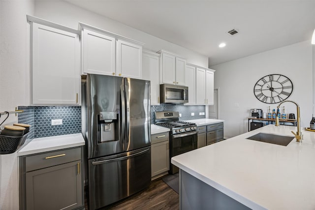 15603 Beltie Dr, Humble, TX 77346 - kitchen featuring appliances with stainless steel finishes, tasteful backsplash, light countertops, dark wood-style flooring, and recessed lighting