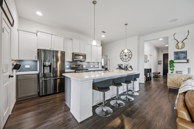 15603 Beltie Dr, Humble, TX 77346 - kitchen featuring appliances with stainless steel finishes, backsplash, dark wood-type flooring, light countertops, and recessed lighting