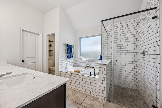 15603 Beltie Dr, Humble, TX 77346 - full bathroom with a bath, a stall shower, vanity, vaulted ceiling, and tile patterned floors